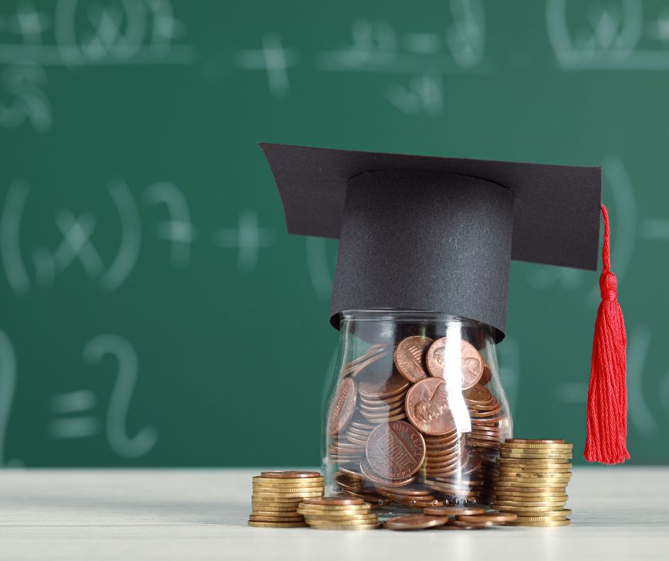 jar of coin with graduation cap in front of chalk board